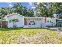Charming single-story home featuring a front porch with chairs and a well-maintained lawn at 3809 N 14Th St, Tampa, FL 33603