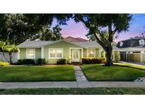Charming single-story home with a lush green lawn, beautiful landscaping, and inviting entrance at 4111 W Granada St, Tampa, FL 33629