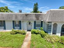 Charming home featuring a well-maintained lawn, a stone pathway, and blue shutters at 4207 Touchton Pl # 4207, New Port Richey, FL 34652