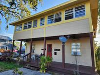 Charming two-story home with a covered front porch and mature landscaping at 516 7Th W Ave # 1, Palmetto, FL 34221
