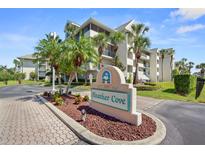 Condo complex with lush tropical landscaping and mature palm trees at 5567 Sea Forest Dr # 323, New Port Richey, FL 34652
