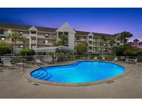 Inviting community pool with a covered seating area perfect for relaxation and enjoying the outdoors in this condo community at 5567 Sea Forest Dr # 323, New Port Richey, FL 34652