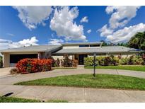 Beautiful single-story home with mature landscaping and a circular driveway at 604 Knollwood Dr, Largo, FL 33770