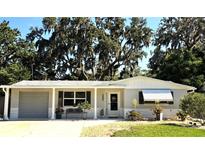 Charming single-story home with gray brick and manicured landscaping at 7427 Banner St, New Port Richey, FL 34653
