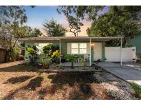 Charming single-story home featuring tidy landscaping and a covered front porch, exuding curb appeal at 1327 S Michigan Ave, Clearwater, FL 33756