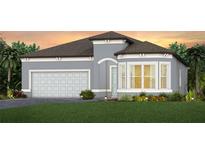 Charming one-story home with a two-car garage and well-manicured front lawn with lush landscaping at 13668 Canyon Ridge Rd, Spring Hill, FL 34610