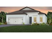 Charming single-story home with a two-car garage, a landscaped yard, and a modern architectural design at 13682 Canyon Ridge Rd, Spring Hill, FL 34610