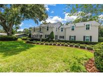 Charming two-story home with manicured lawn, lush green landscaping, and inviting curb appeal at 1628 Long Bow Ln, Clearwater, FL 33764