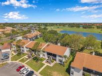 Scenic aerial view of condo community overlooking golf course and lake under a blue sky at 2049 Skimmer W Ct # 311, Clearwater, FL 33762