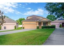 Charming two-story home featuring a well-manicured lawn and inviting front porch at 320 Roxbury Crossing Ct, Valrico, FL 33594