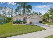 Charming home with a well-manicured lawn, mature landscaping, and a cozy, inviting front entrance at 5422 Braddock Dr, Zephyrhills, FL 33541