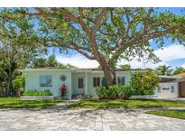 Charming single-story home features a welcoming front yard with mature landscaping at 745 Bruce Ave, Clearwater Beach, FL 33767