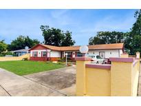 Charming single Gathering home with well-maintained lawn and eye-catching exterior details and colorful accents at 7710 Jackson Springs Rd, Tampa, FL 33615
