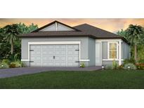 Charming single story home featuring a gray exterior, manicured lawn, and a two-car garage at 13740 Rocky Pine Pl, Spring Hill, FL 34610