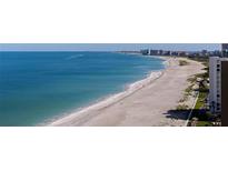Expansive beach view showcasing the pristine white sand and clear blue water, perfect for relaxation and recreation at 1520 Gulf Blvd # 1502, Clearwater Beach, FL 33767