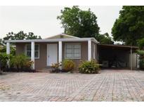 Charming single-story home with a brick driveway and covered carport at 3110 W Haya St, Tampa, FL 33614