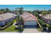 Well-maintained single-Gathering home with a red tile roof, neat landscaping, and attached two-car garage at 4415 Muirfiled Dr, Bradenton, FL 34210