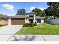 Charming one-story home with a well-manicured lawn, a two-car garage, and a beautiful exterior at 4511 Preston Woods Dr, Valrico, FL 33596