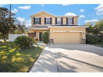 Charming two-story home with a well-manicured lawn and a two-car garage at 8607 Tidal Breeze Dr, Riverview, FL 33569