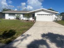 Charming single-story home with a well-manicured lawn and a two-car garage in a quiet neighborhood at 1480 Fairfield Dr, Clearwater, FL 33764