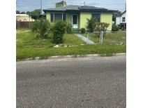 Charming single-Gathering home with mature landscaping, solar panels, and a cozy front entrance at 1557 15Th S St, St Petersburg, FL 33705