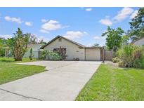 Charming single-story home featuring a well-manicured lawn and a private, attached single car garage at 1811 49Th N St, St Petersburg, FL 33710