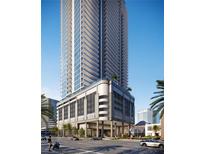 Stunning high-rise building showcasing modern architecture, balconies, and street view with palm trees under a clear blue sky at 235 1St S Ave # 3708, St Petersburg, FL 33701