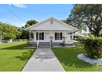 Charming single-story home with a well-manicured lawn and inviting front porch, perfect for relaxing outdoors at 4112 E Ellicott St, Tampa, FL 33610