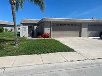 Charming single-story home featuring an attached garage and landscaping at 587 Boca Ciega Point N Blvd, St Petersburg, FL 33708