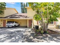 Inviting townhouse with covered parking, landscaped entry, and charming curb appeal at 7608 Pasa Dobles Ct, Tampa, FL 33615