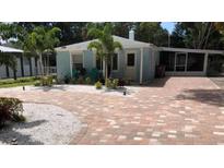 Charming single-story home with brick driveway and tropical landscaping at 111 12Th Ave, Indian Rocks Beach, FL 33785