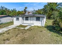 Charming single-story home featuring a well-maintained front yard and classic architectural details at 111 W Keyes Ave, Tampa, FL 33602