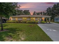 Charming single-story home with a well-manicured lawn and a convenient carport at 4816 N Fremont Ave, Tampa, FL 33603