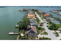 Waterfront home with a private dock and solar panels on the roof at 8 Sunset Bay Dr, Belleair, FL 33756