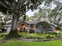 Charming home with manicured landscaping, large front tree and inviting curb appeal at 11760 Ashley Ct, Seminole, FL 33772