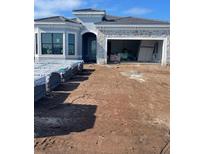 New construction single-Gathering home featuring stone accents, a modern design, and an attached two-car garage at 19422 Indian Rock Pl, Lakewood Ranch, FL 34211