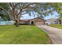 Charming single-story home featuring a spacious lawn and a large shade tree in the front yard at 2584 58Th S Ave, St Petersburg, FL 33710