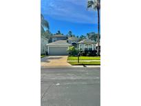Charming home with a well-manicured lawn, mature landscaping, and a two-car garage at 27312 Edenfield Dr, Wesley Chapel, FL 33544