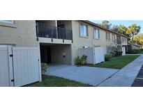 Well-maintained exterior with lush landscaping, private patios, and assigned parking at 4215 E Bay Dr # 1506C, Clearwater, FL 33764