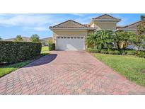 Charming home with a brick driveway, a two-car garage, and mature landscaping, adding curb appeal at 4760 Wheel House Dr, New Port Richey, FL 34652