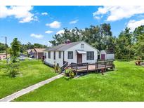 Charming single-story home with a cozy front porch and well-maintained lawn at 812 W Orient St, Tampa, FL 33603