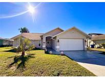 Charming single-story home featuring a well-manicured lawn and an attached two-car garage at 8616 Pinafore Dr, New Port Richey, FL 34653