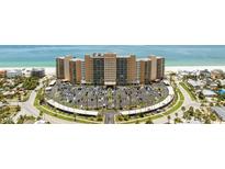 Stunning aerial view of beachfront condo building with manicured grounds and ample parking at 880 Mandalay Ave # C512, Clearwater Beach, FL 33767