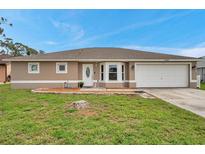 Charming single-story home featuring a well-manicured lawn and a welcoming front entrance at 15442 Arvin Dr, Brooksville, FL 34604