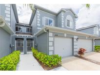 Inviting two-story townhome with a two-car garage and well-manicured landscaping at 18136 Nassau Point Dr, Tampa, FL 33647
