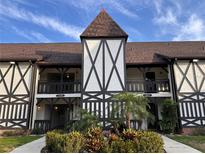 Beautiful condo exterior with a decorative tower element, private balconies, and lush landscaping at 320 N Bayshore Blvd # 203, Clearwater, FL 33759