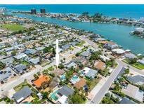 Coastal home with lush landscaping, a pool, and easy access to the beach and waterfront, shown from above at 429 87Th Ave, St Pete Beach, FL 33706