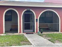 Charming front entrance featuring arched openings and a secure screen door at 6446 71St N St, Pinellas Park, FL 33781
