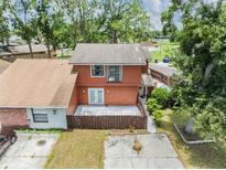Charming two-story home featuring a spacious backyard and a private outdoor patio area at 10520 Winrock Pl, Tampa, FL 33624