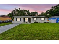 Charming single-story home with a well-manicured lawn and a cozy, inviting facade at 2027 Balfour Cir, Tampa, FL 33619
